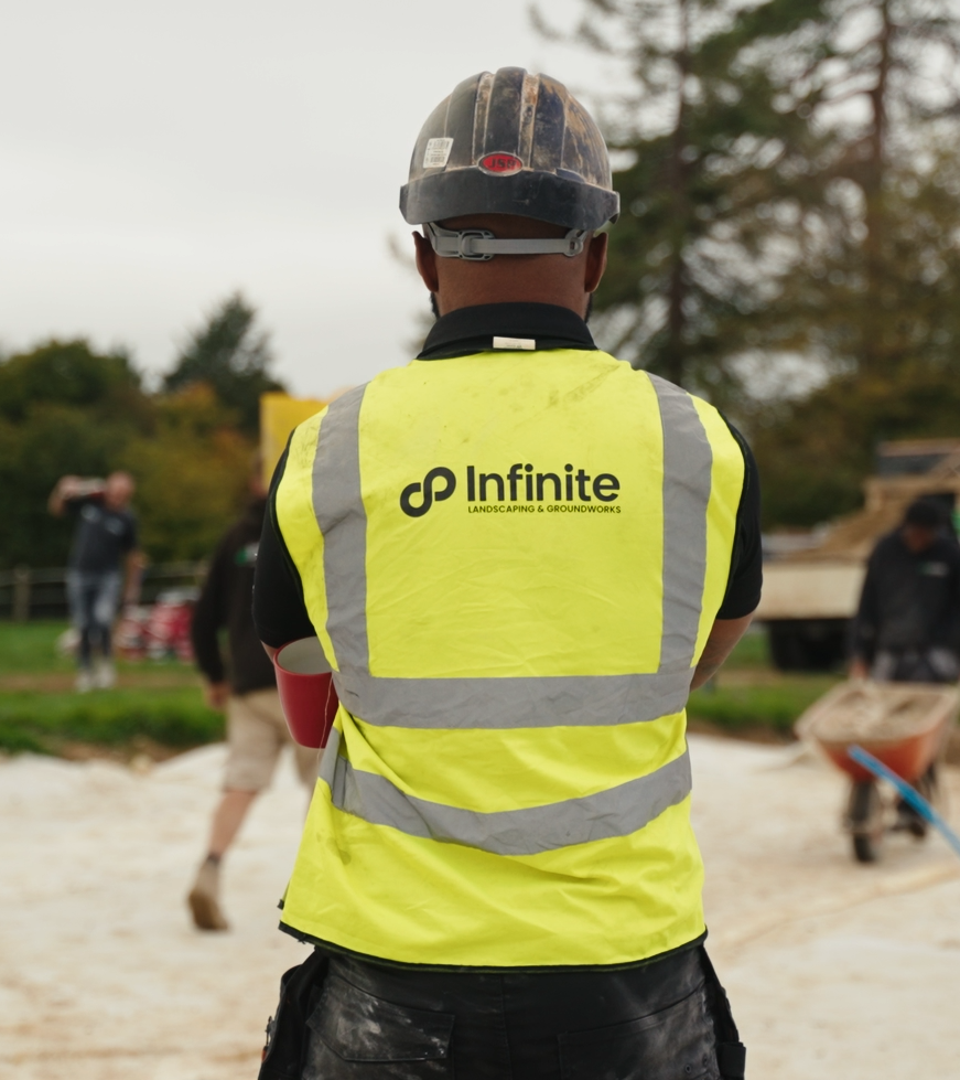 A member of the Infinite luxury landscaping team on site in branded workwear